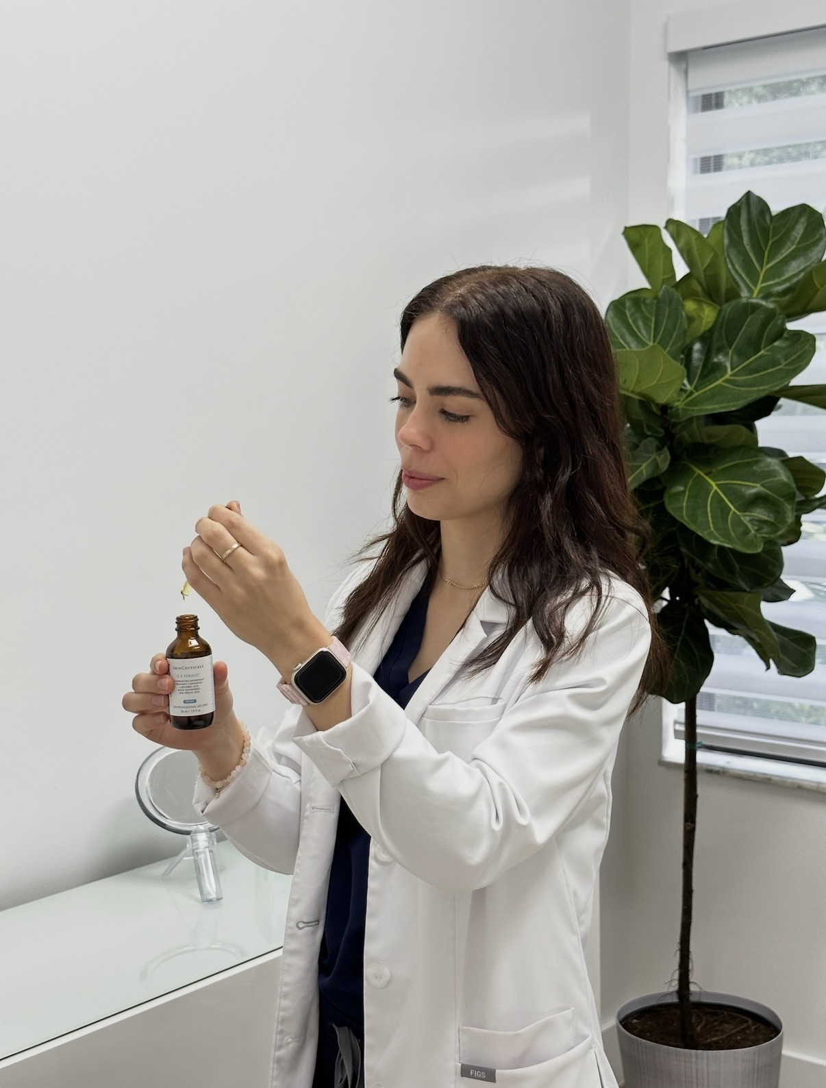 Provider with a SkinCeuticals serum in the consultation room at Miami Skin Spa in Brickell, Miami.